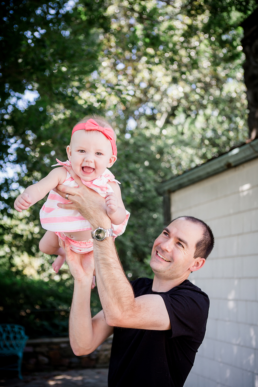 Dad holding daughter in the air by Knoxville Wedding Photographer, Amanda May Photos.