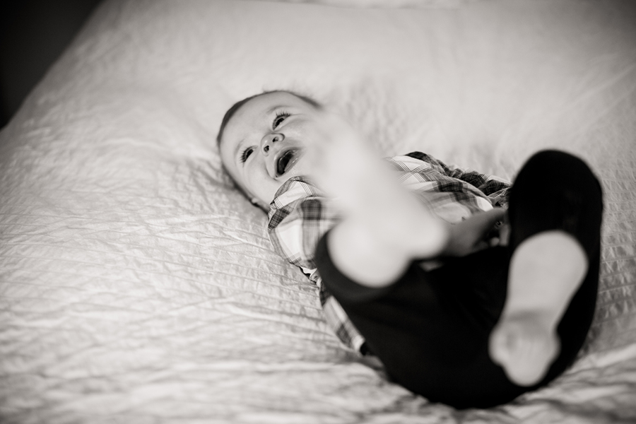 Little girl laying on the bed by Knoxville Wedding Photographer, Amanda May Photos.