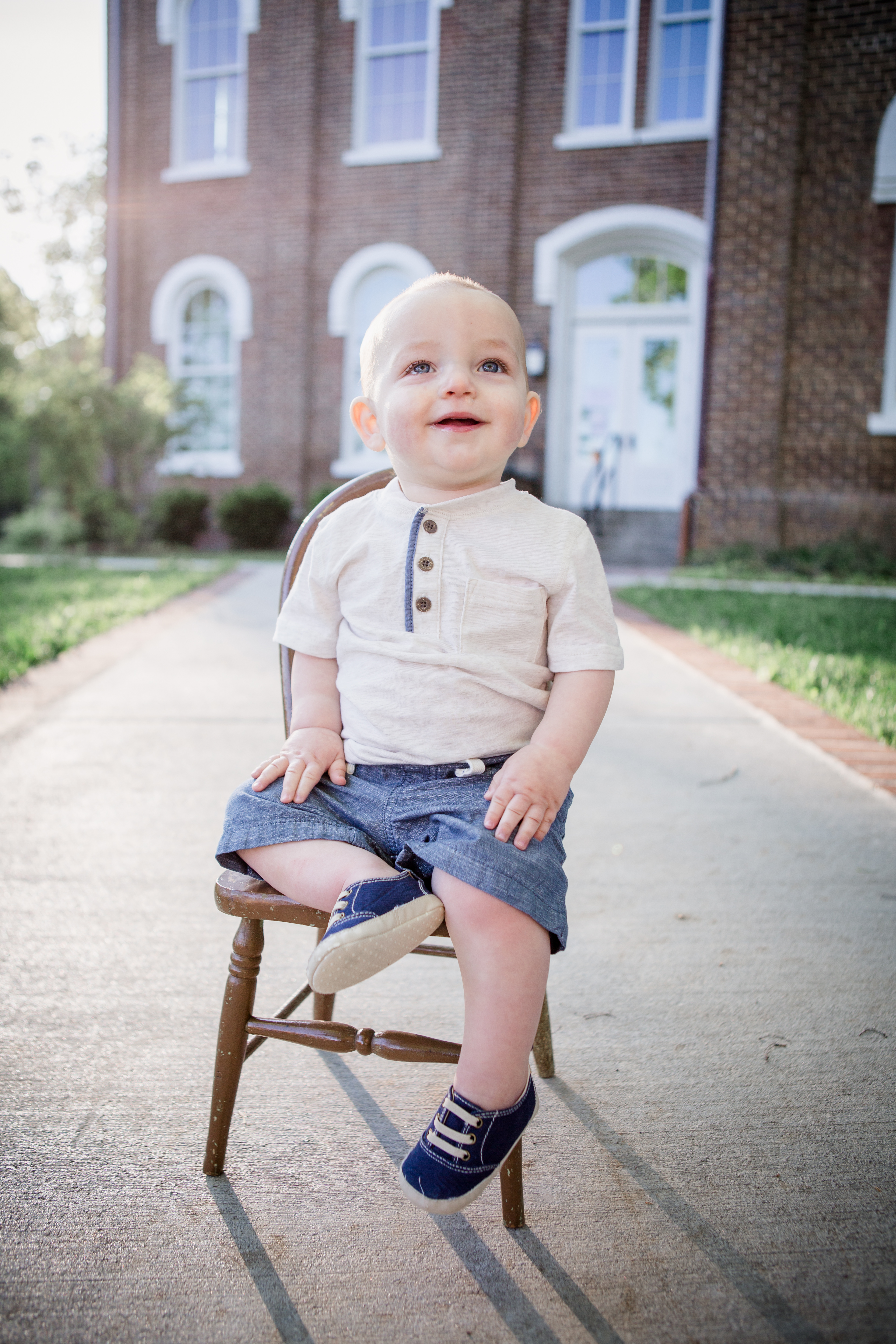 Sitting in a wooden chair by Knoxville Wedding Photographer, Amanda May Photos.