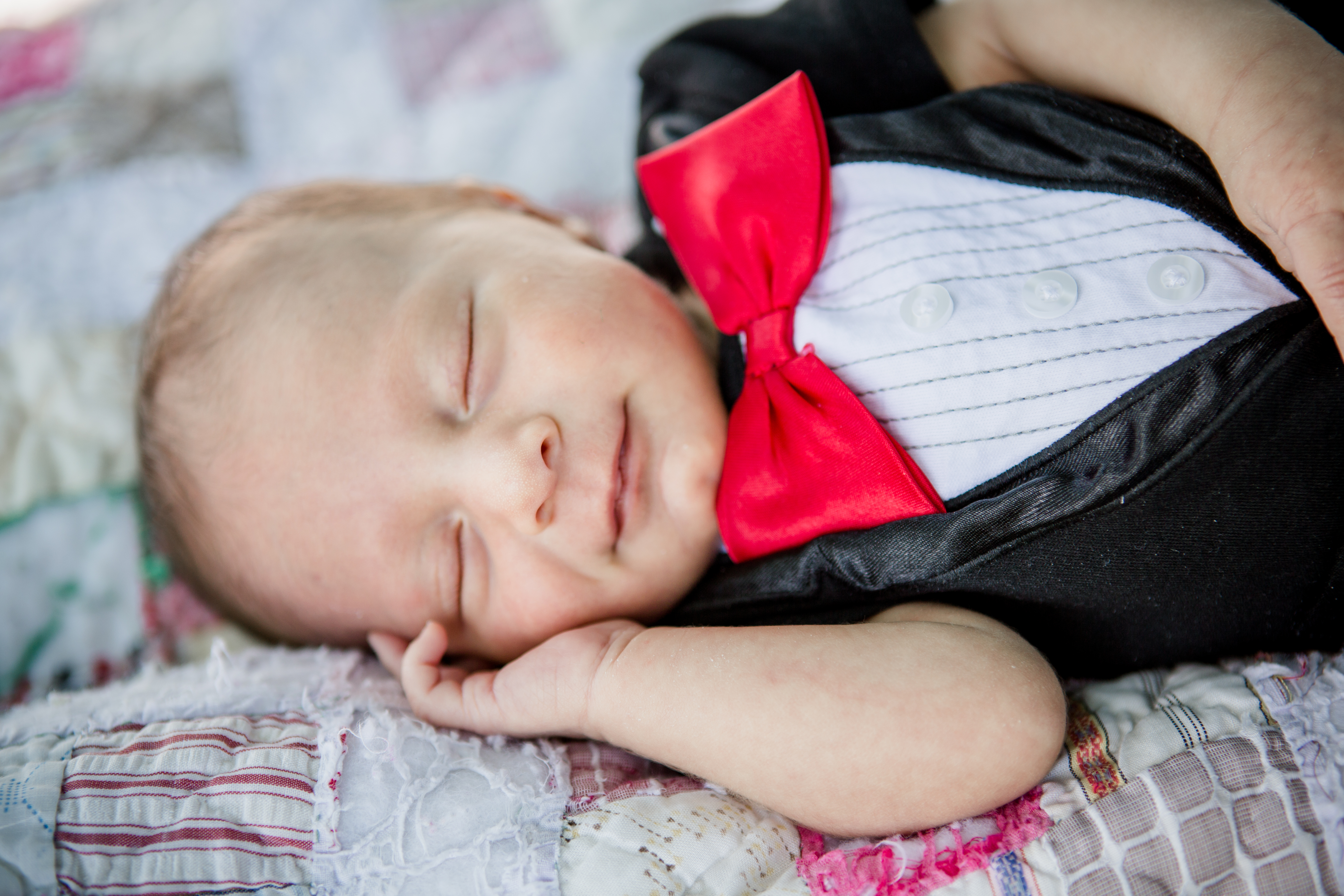 Newborn in a red bowtie by Knoxville Wedding Photographer, Amanda May Photos.
