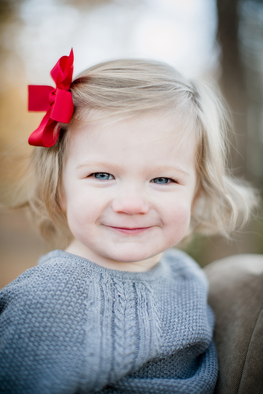 Smiling with red bows by Knoxville Wedding Photographer, Amanda May Photos.