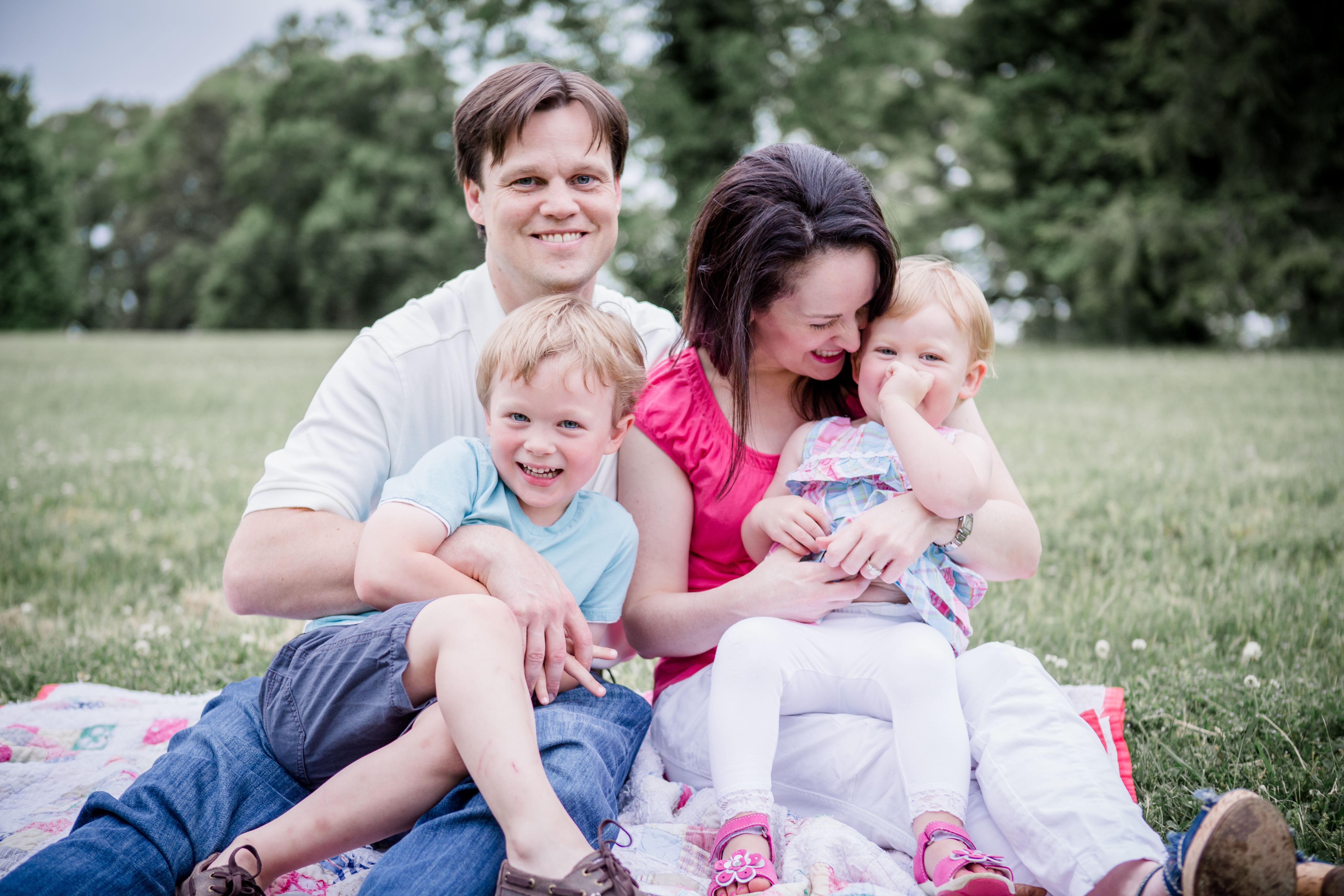 Family of four playing in the grass by Knoxville Wedding Photographer, Amanda May Photos.