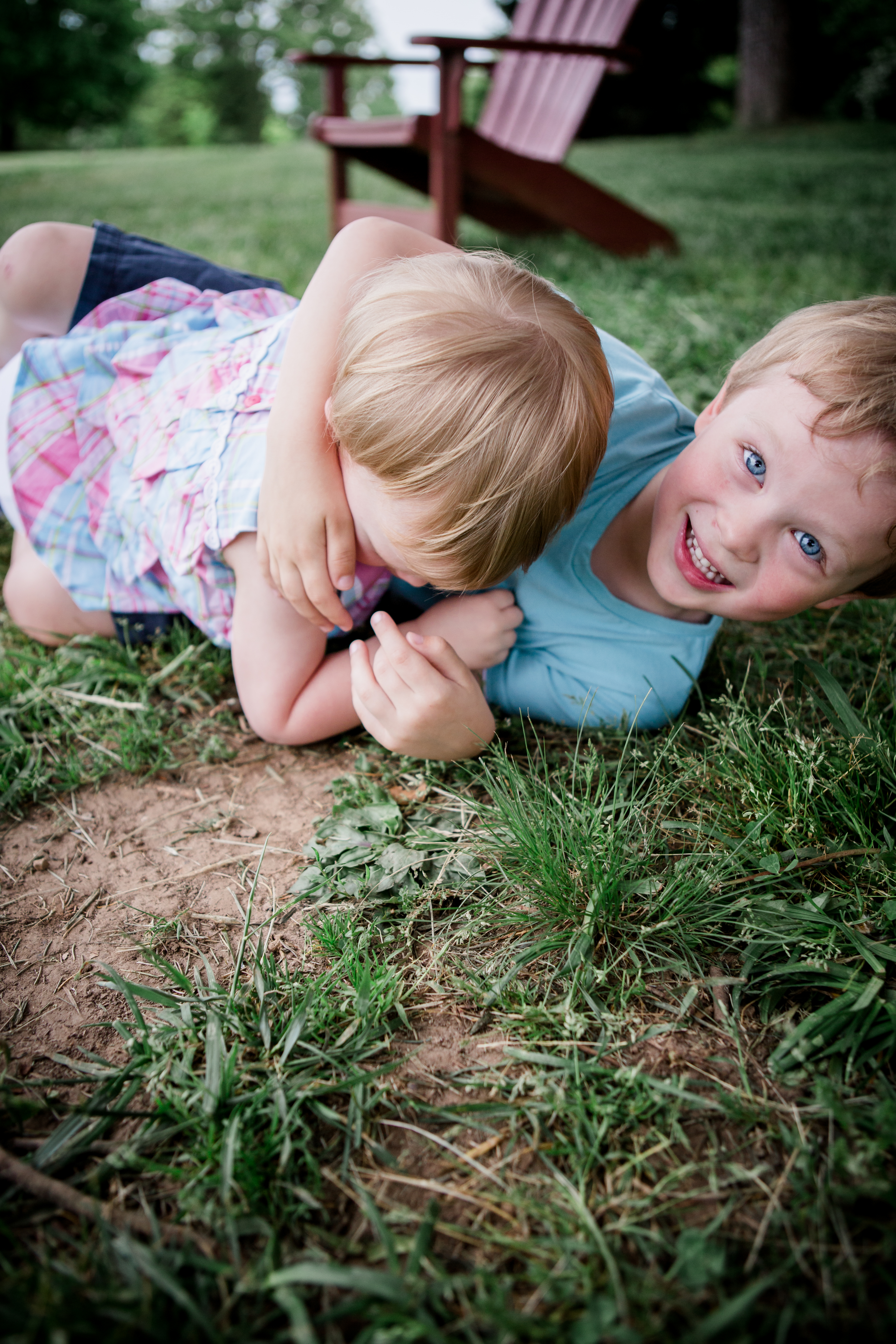 Brother sister rolling in grass by Knoxville Wedding Photographer, Amanda May Photos.