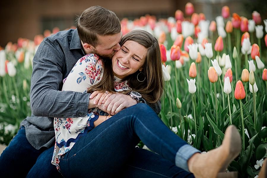 Kissing in the tulips at this 2018 favorite engagements by Knoxville Wedding Photographer, Amanda May Photos.