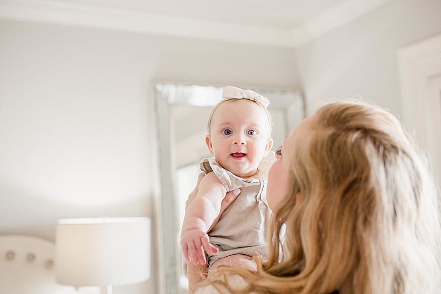 Mom holding baby at this Lifestyle 6 Month Session by Knoxville Wedding Photographer, Amanda May Photos.
