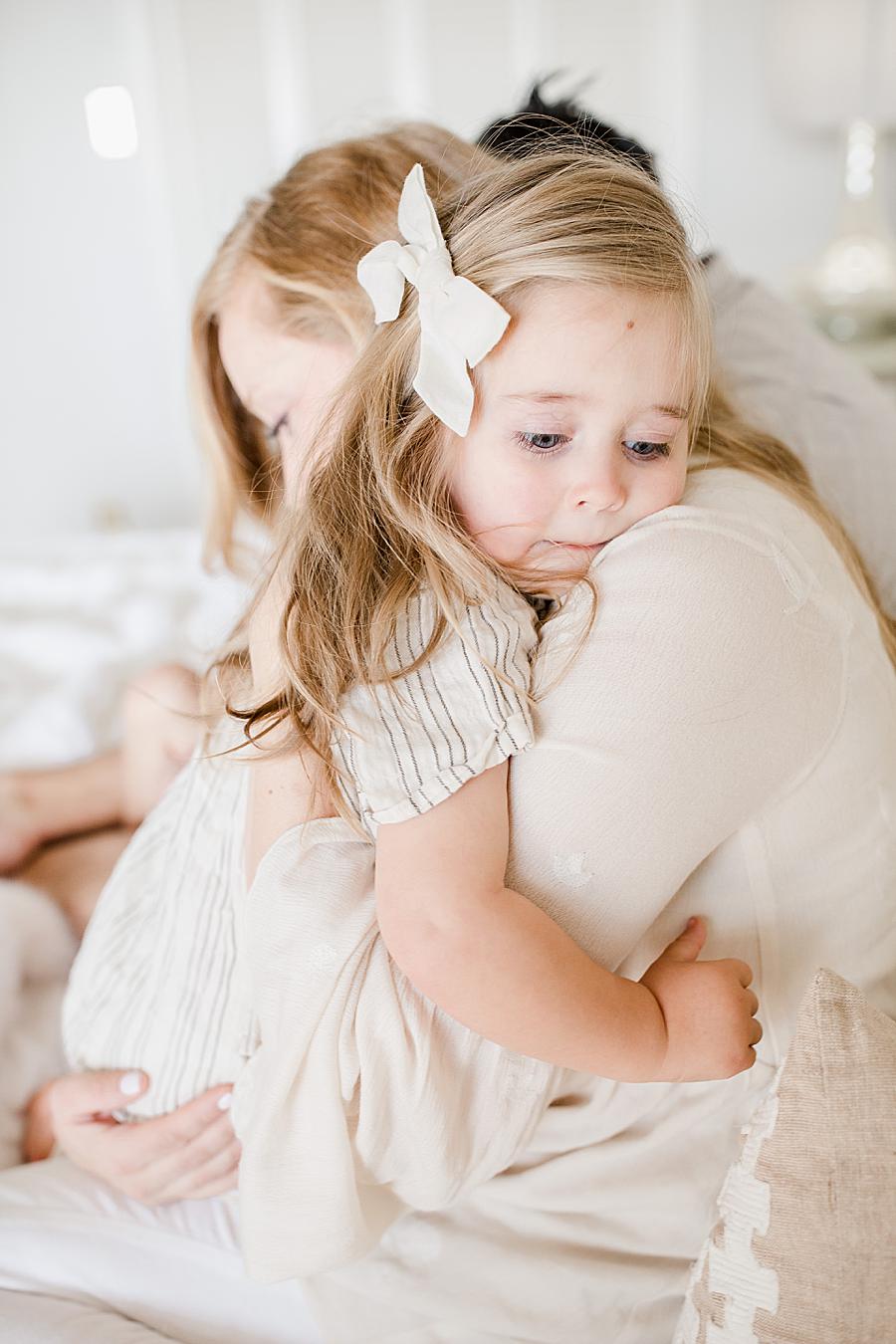 Hugging mom at this Lifestyle 6 Month Session by Knoxville Wedding Photographer, Amanda May Photos.