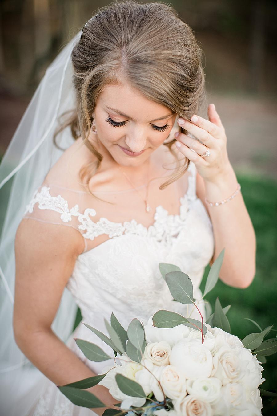 Brushing away hair at this Castleton Farms Bridal session by Knoxville Wedding Photographer, Amanda May Photos.
