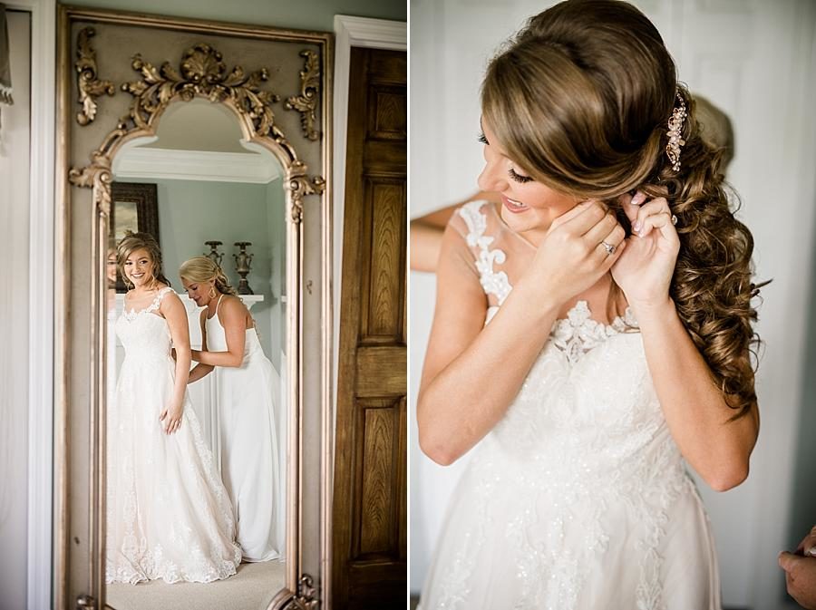 Putting on earrings at this Castleton Farms Wedding by Knoxville Wedding Photographer, Amanda May Photos.