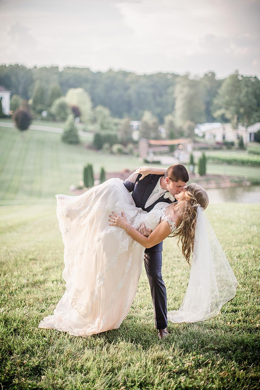 Kissing in front of the fountain at this Castleton Farms Wedding by Knoxville Wedding Photographer, Amanda May Photos.