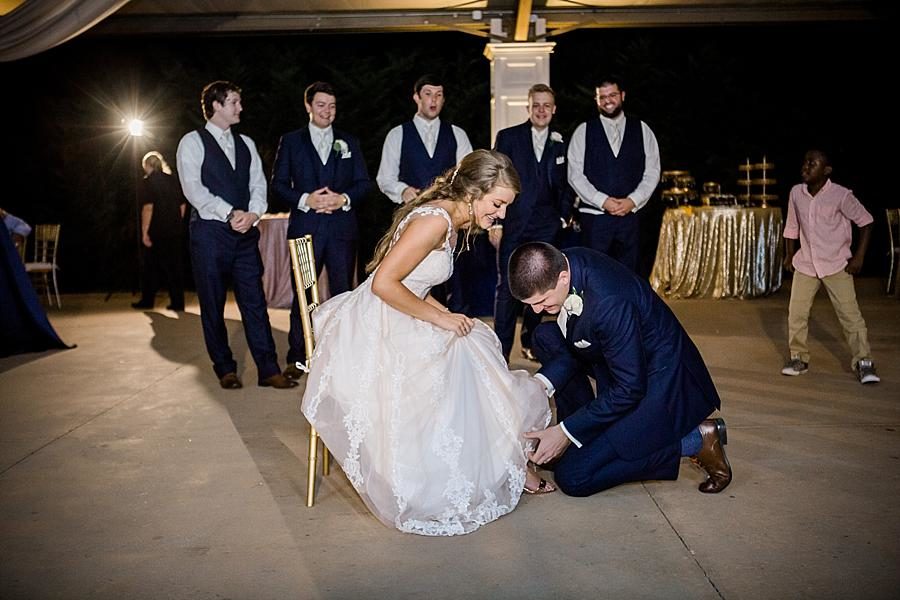 Getting the garter at this Castleton Farms Wedding by Knoxville Wedding Photographer, Amanda May Photos.