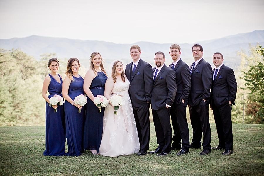 Whole wedding party serious in front of mountains at this Christopher Place wedding by Knoxville Wedding Photographer, Amanda May Photos