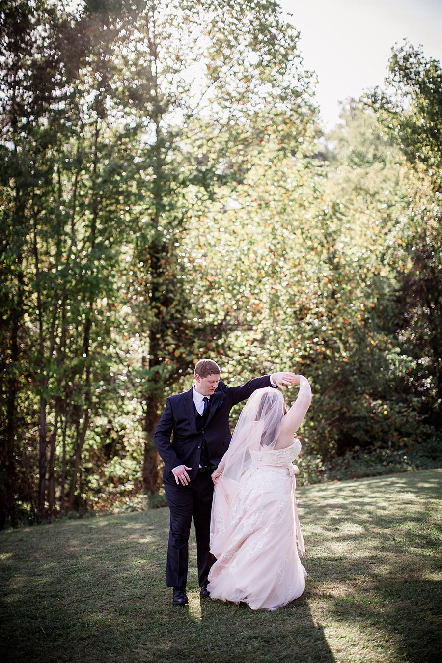 Twirling his bride at this Christopher Place wedding by Knoxville Wedding Photographer, Amanda May Photos