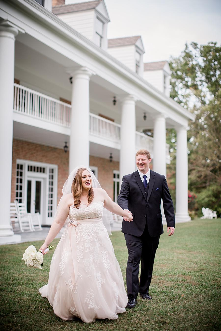 Bride and groom running at this Christopher Place wedding by Knoxville Wedding Photographer, Amanda May Photos