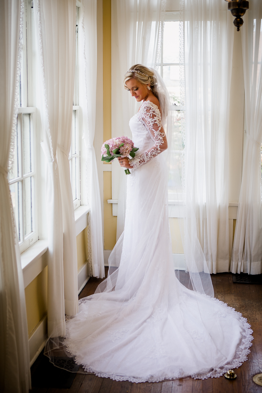 Twisting around in front of window at Historic Westwood by Knoxville Wedding Photographer, Amanda May Photos.
