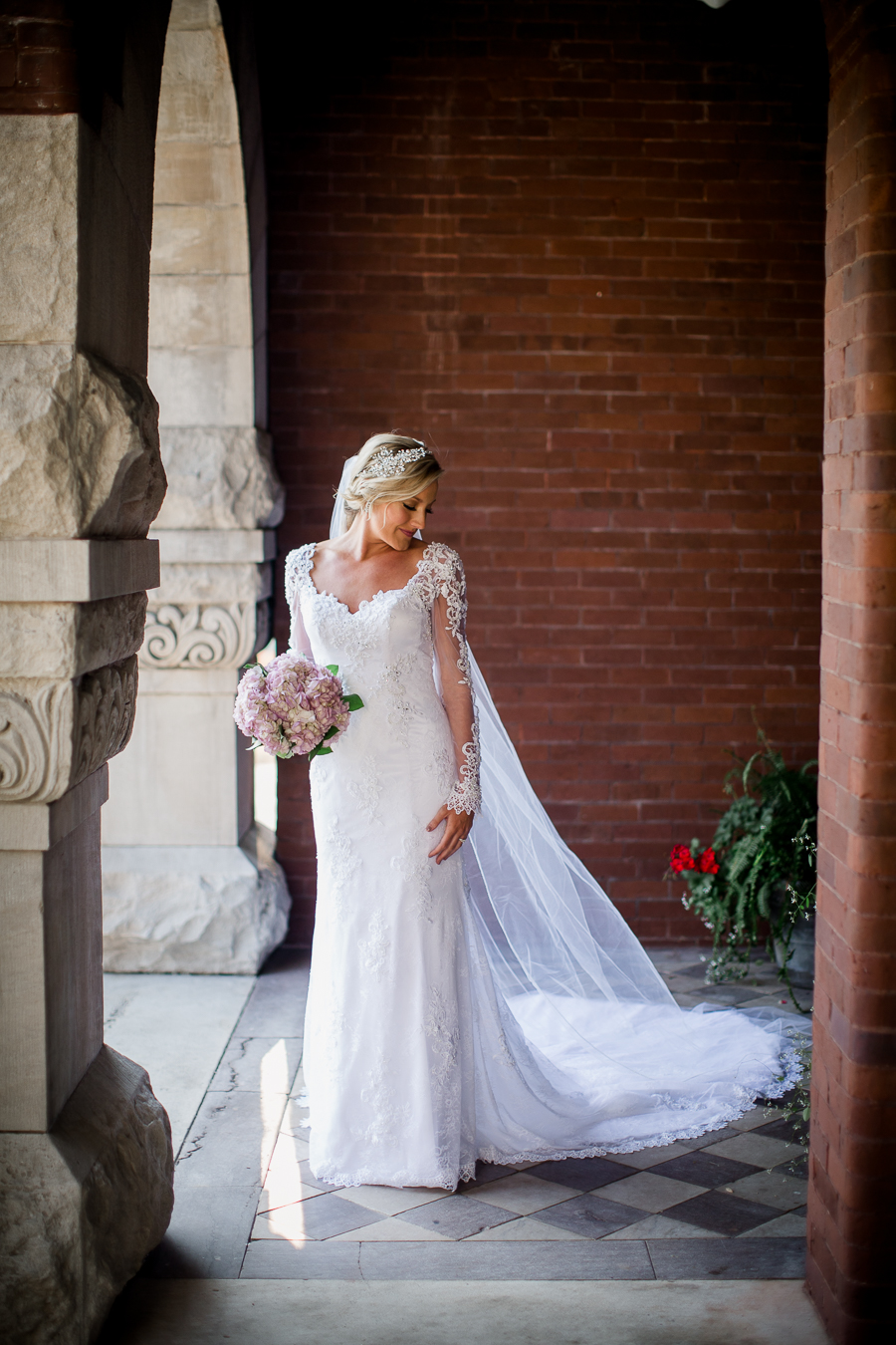 Looking down her shoulder in arch at Historic Westwood by Knoxville Wedding Photographer, Amanda May Photos.