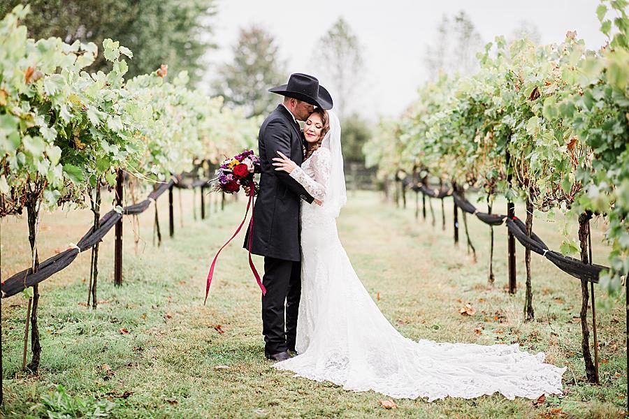 Bride and groom in vineyard at this Arrington Vineyard wedding by Knoxville Wedding Photographer, Amanda May Photos.