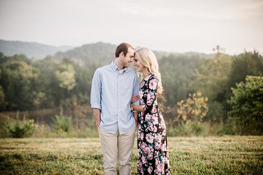 Holding his arm at this Family Farm Engagement Session by Knoxville Wedding Photographer, Amanda May Photos.