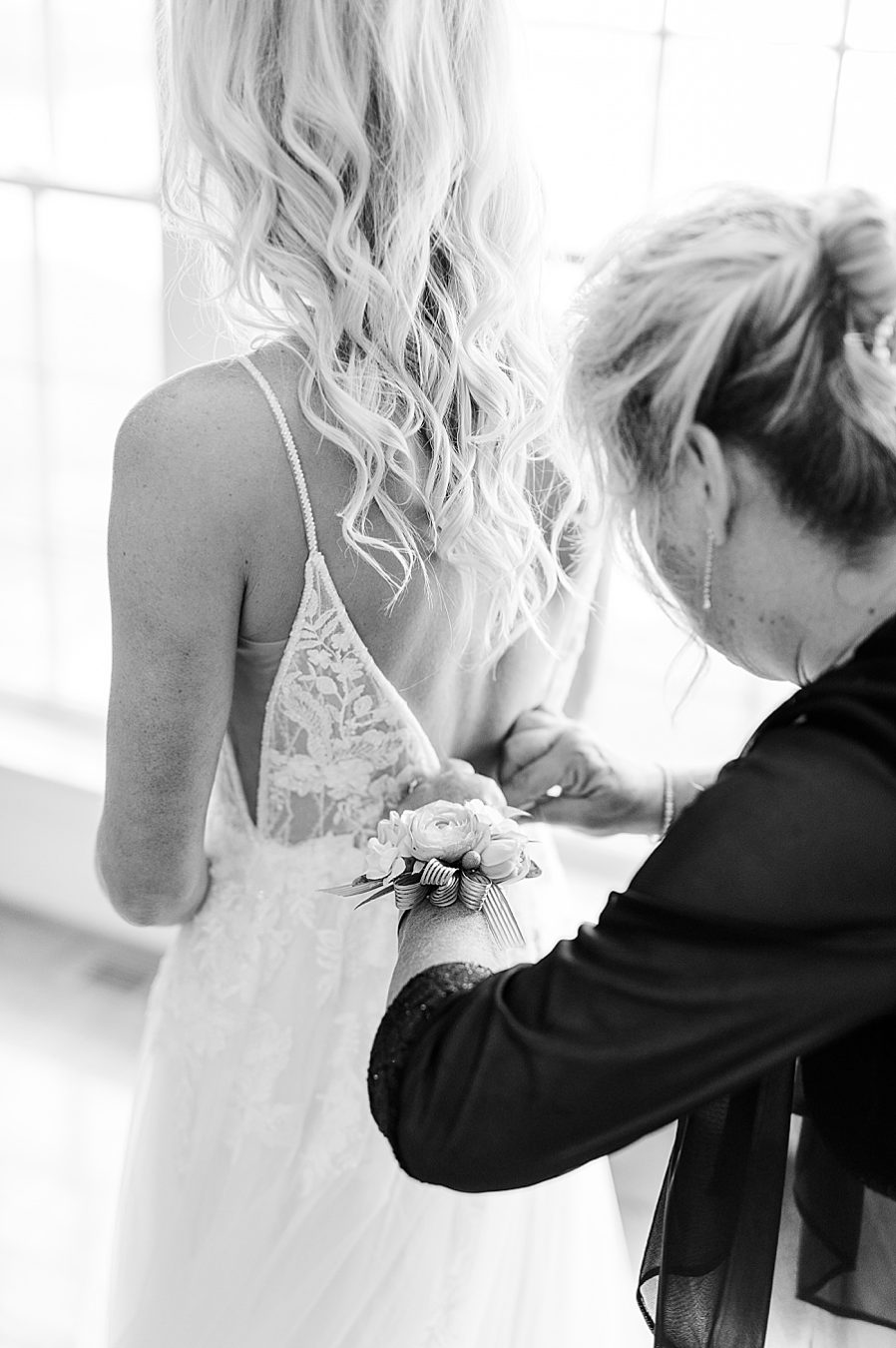 buttoning wedding dress at this associate wedding at marblegate