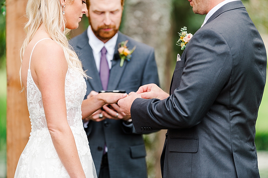 exchanging rings at this associate wedding at marblegate