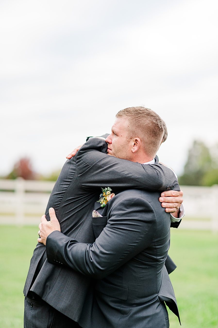 groom hugging dad at this associate wedding at marblegate