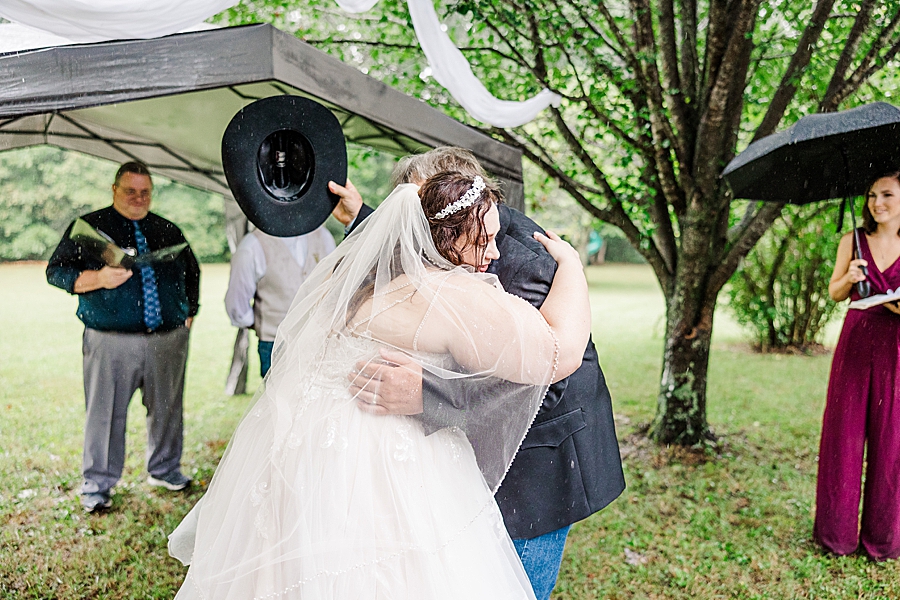 bride hugging dad at this backyard wedding