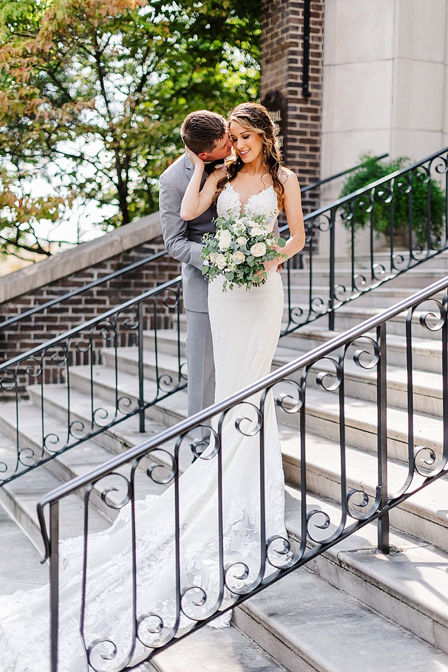 bride and groom on church steps at this black tie wedding