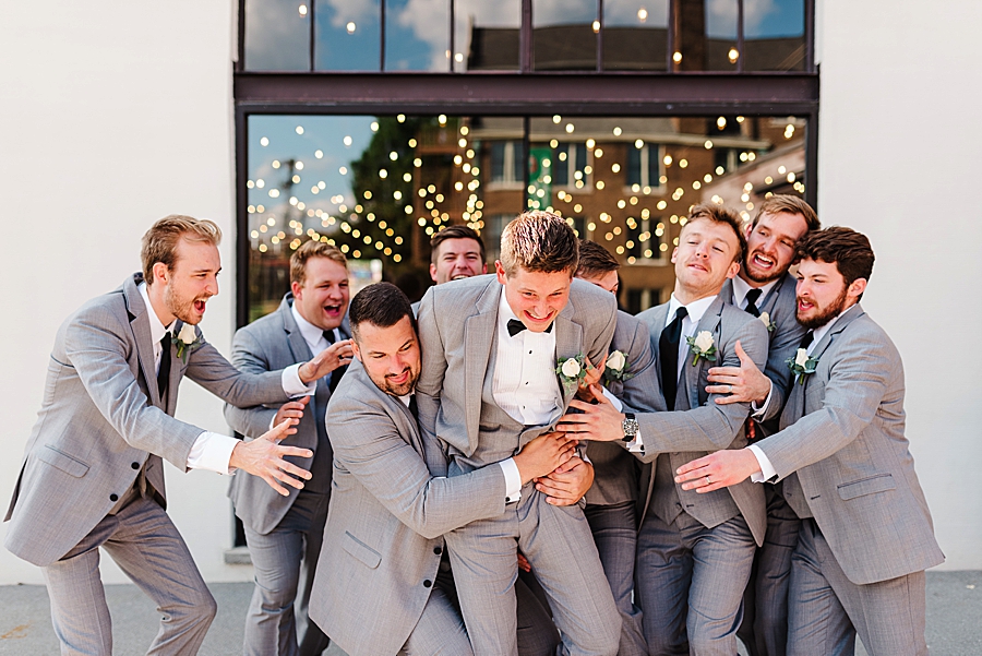 groom and groomsmen being silly at this black tie wedding