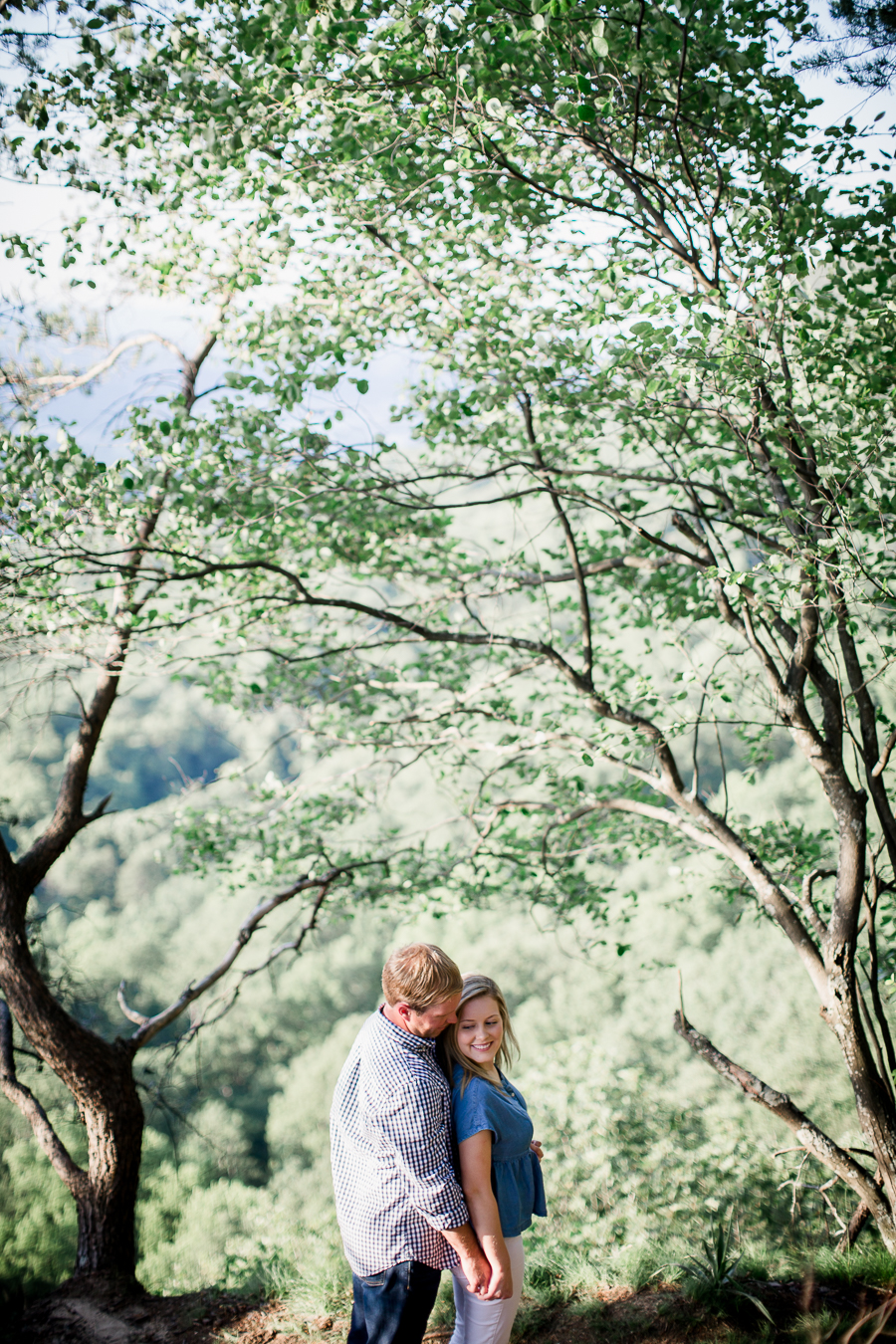 Holding hands from behind at Sunset Rock in Chattanooga by Knoxville Wedding Photographer Amanda May Photos.