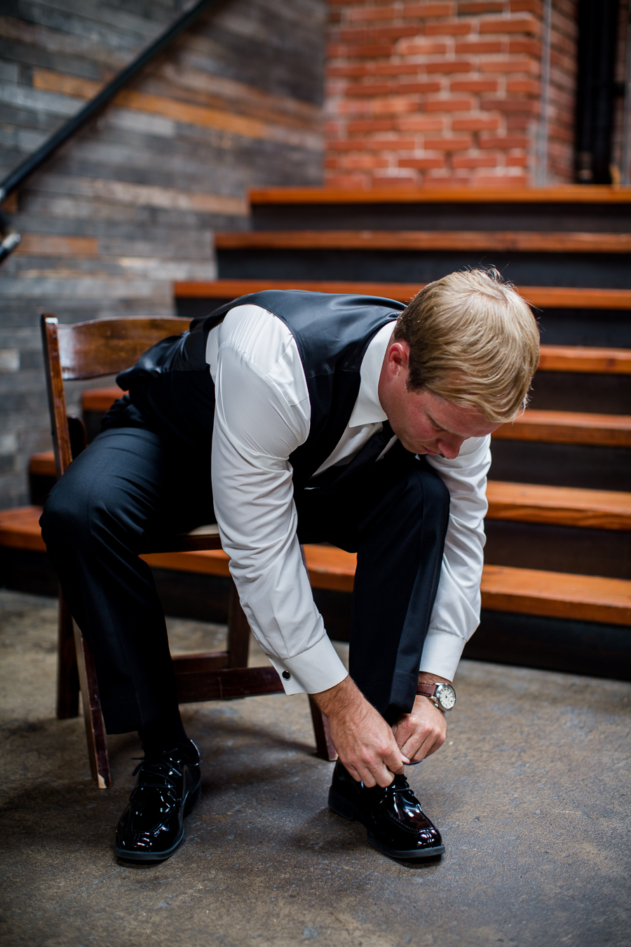 Groom putting on shoes at this wedding at The Standard by Knoxville Wedding Photographer, Amanda May Photos.
