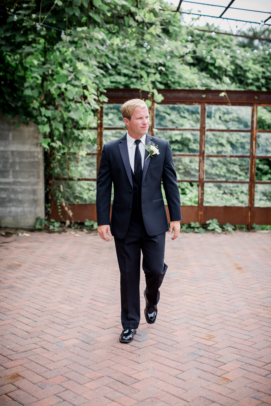 Groom walking at this wedding at The Standard by Knoxville Wedding Photographer, Amanda May Photos.