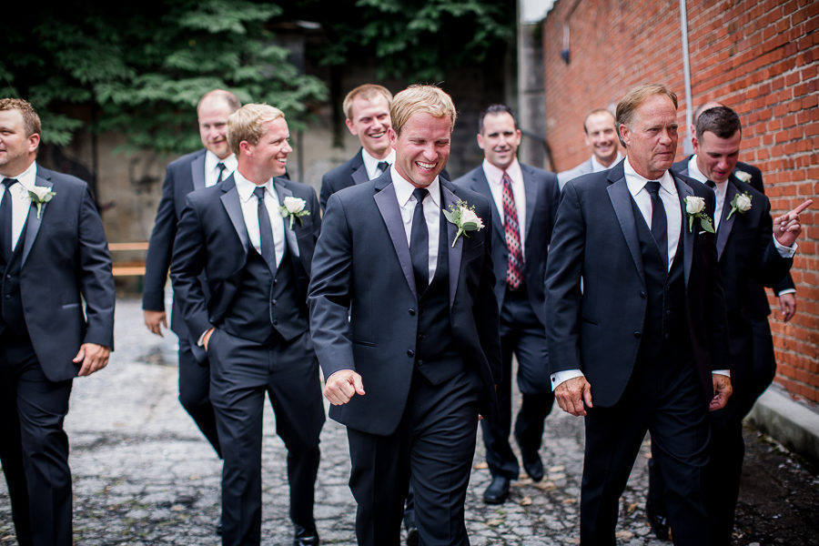 Groom walking and laughing with groomsmen at this wedding at The Standard by Knoxville Wedding Photographer, Amanda May Photos.