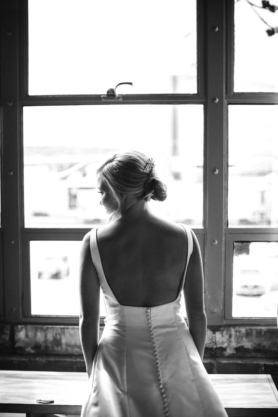 Black and white of back of dress in front of window at this wedding at The Standard by Knoxville Wedding Photographer, Amanda May Photos.
