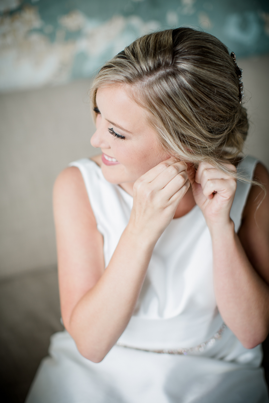 Bride putting on earrings at this wedding at The Standard by Knoxville Wedding Photographer, Amanda May Photos.