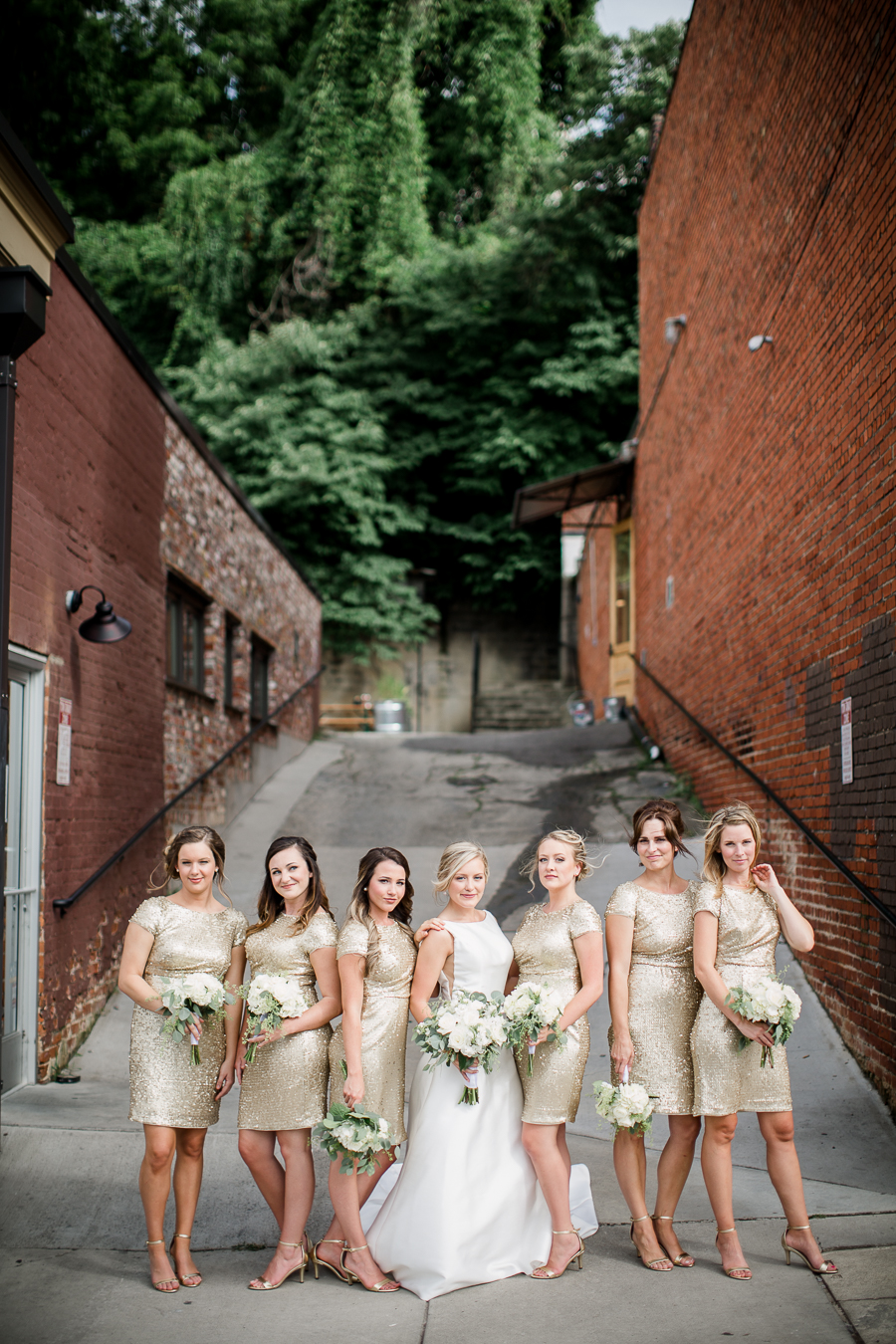 Bride with bridesmaids in alleyway at this wedding at The Standard by Knoxville Wedding Photographer, Amanda May Photos.