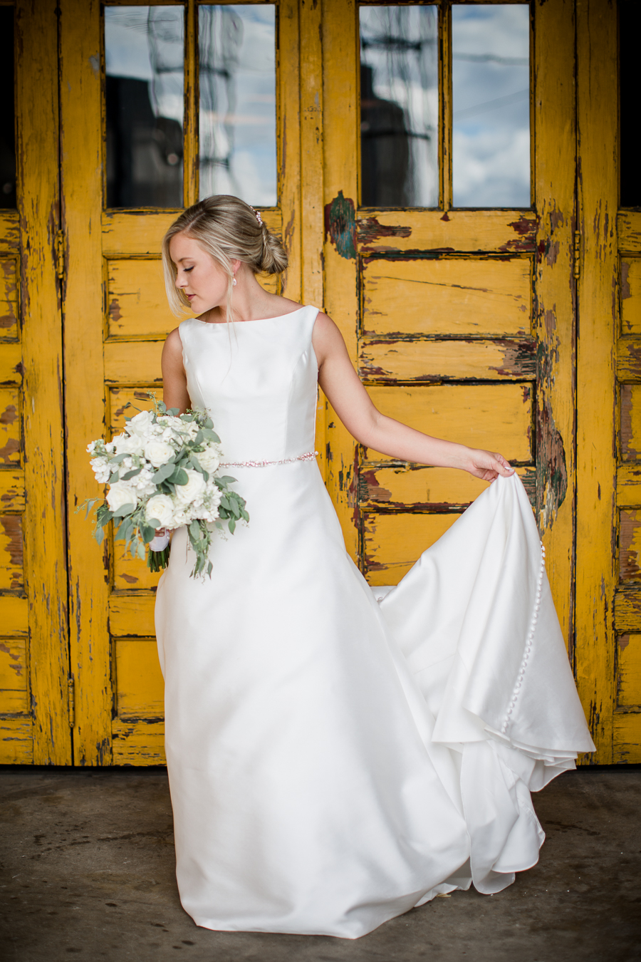 Bride in front of yellow door at this wedding at The Standard by Knoxville Wedding Photographer, Amanda May Photos.