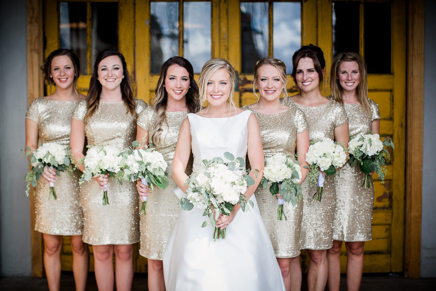Bride with bridesmaids in front of yellow door at this wedding at The Standard by Knoxville Wedding Photographer, Amanda May Photos.