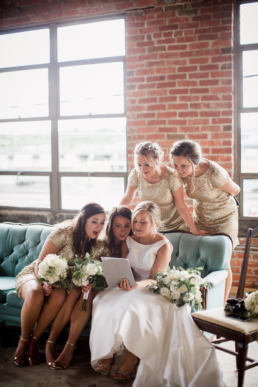 Bridal party looking at ipad at this wedding at The Standard by Knoxville Wedding Photographer, Amanda May Photos.
