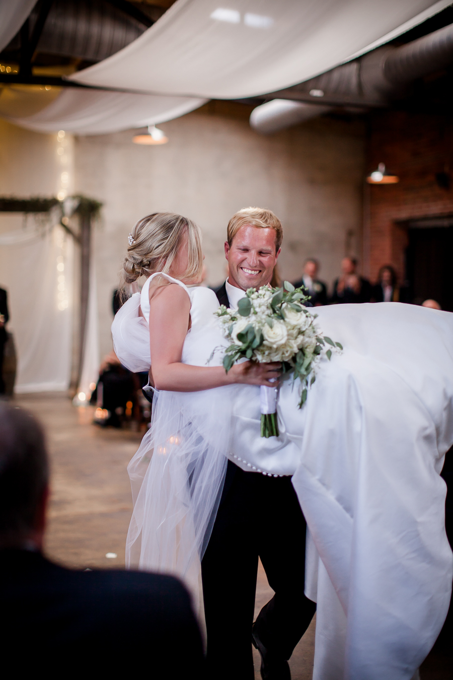 Carrying bride down aisle at this wedding at The Standard by Knoxville Wedding Photographer, Amanda May Photos.