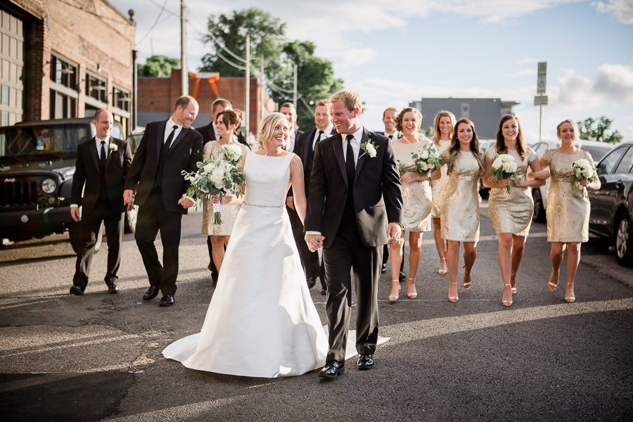 Full bridal party walking in street at this wedding at The Standard by Knoxville Wedding Photographer, Amanda May Photos.