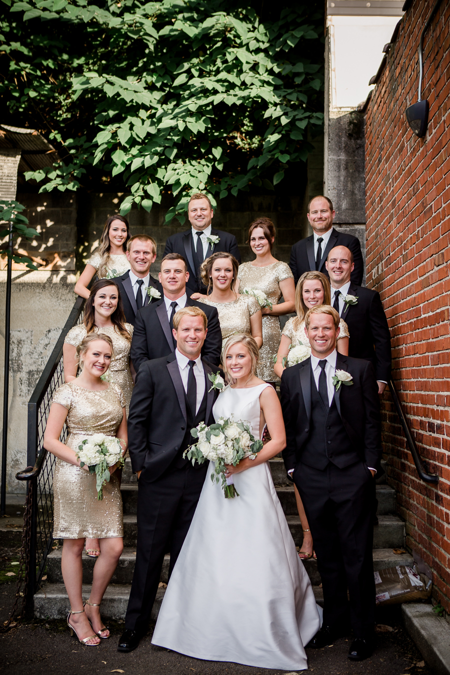 Full bridal party on staircase outside at this wedding at The Standard by Knoxville Wedding Photographer, Amanda May Photos.