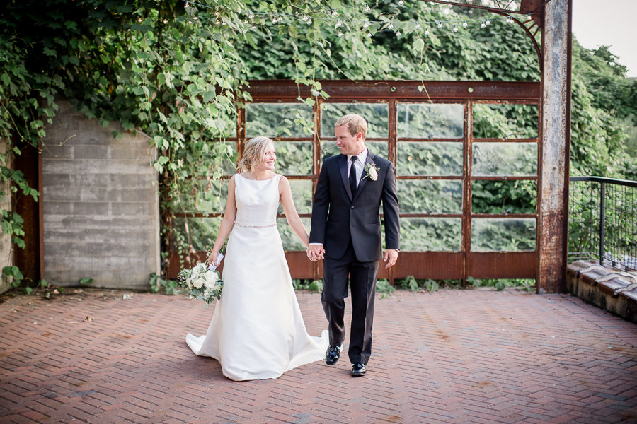 Walking holding hands at this wedding at The Standard by Knoxville Wedding Photographer, Amanda May Photos.