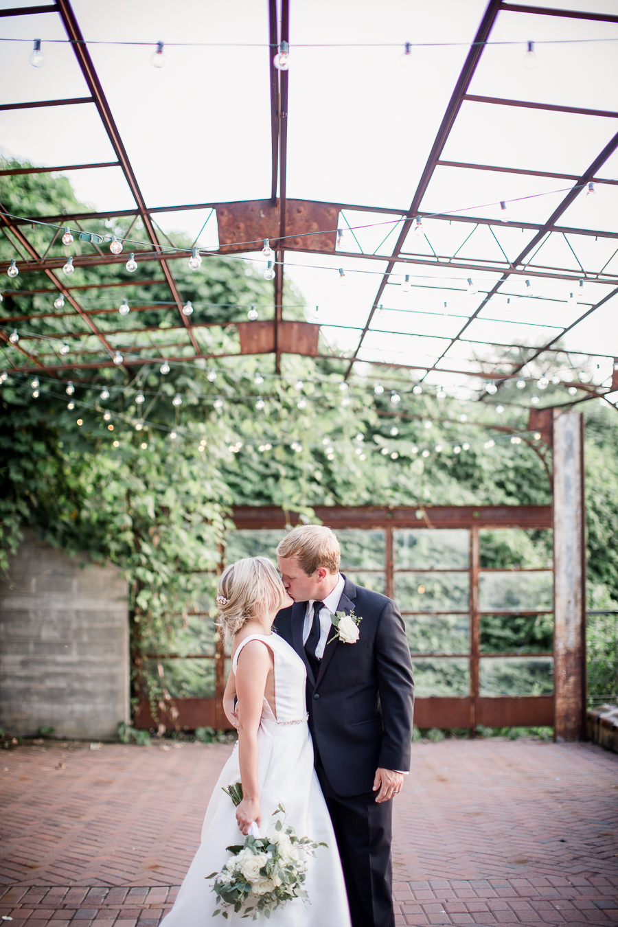 Kissing on roof top at this wedding at The Standard by Knoxville Wedding Photographer, Amanda May Photos.