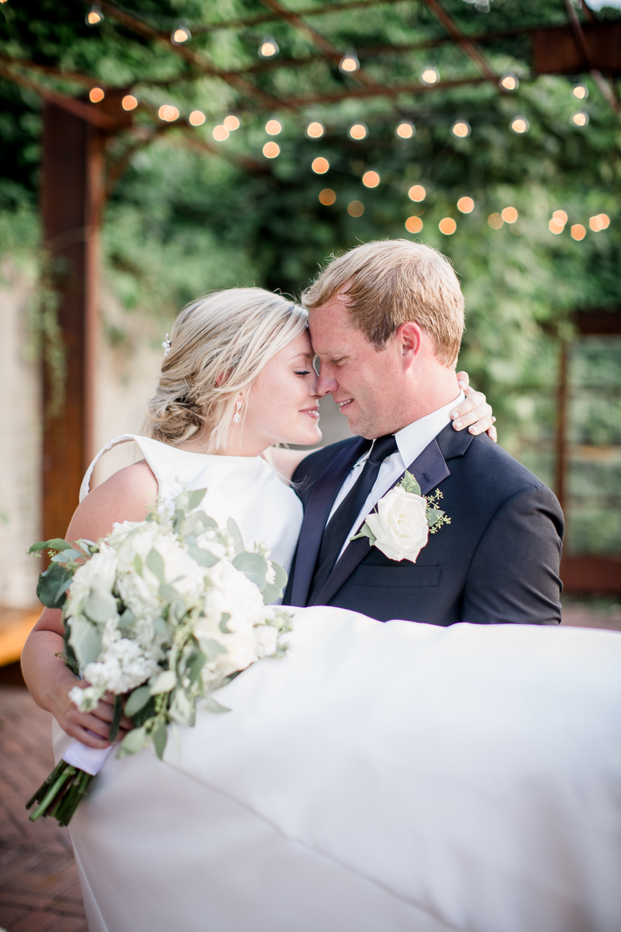 Kissing holding bride at this wedding at The Standard by Knoxville Wedding Photographer, Amanda May Photos.