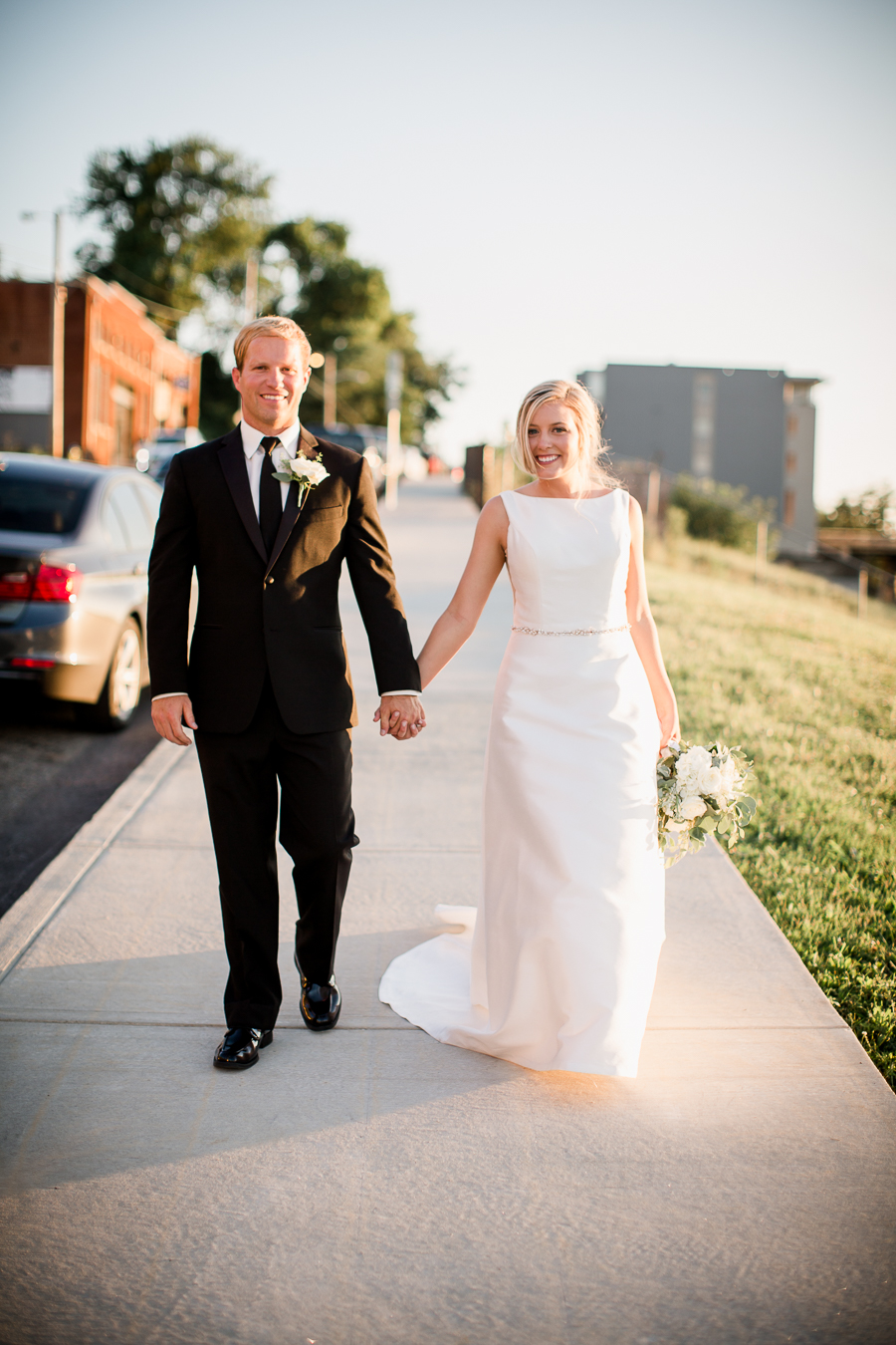 Walking holding hands outside at this wedding at The Standard by Knoxville Wedding Photographer, Amanda May Photos.