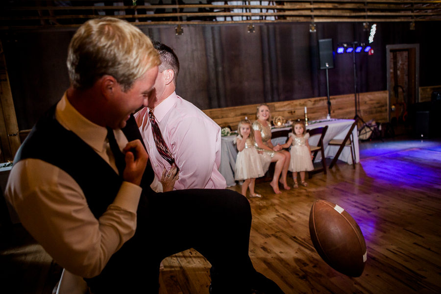 Groom throwing football at this wedding at The Standard by Knoxville Wedding Photographer, Amanda May Photos.