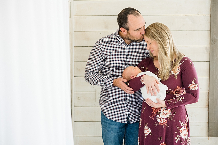 kiss on the forehead at this bright newborn session