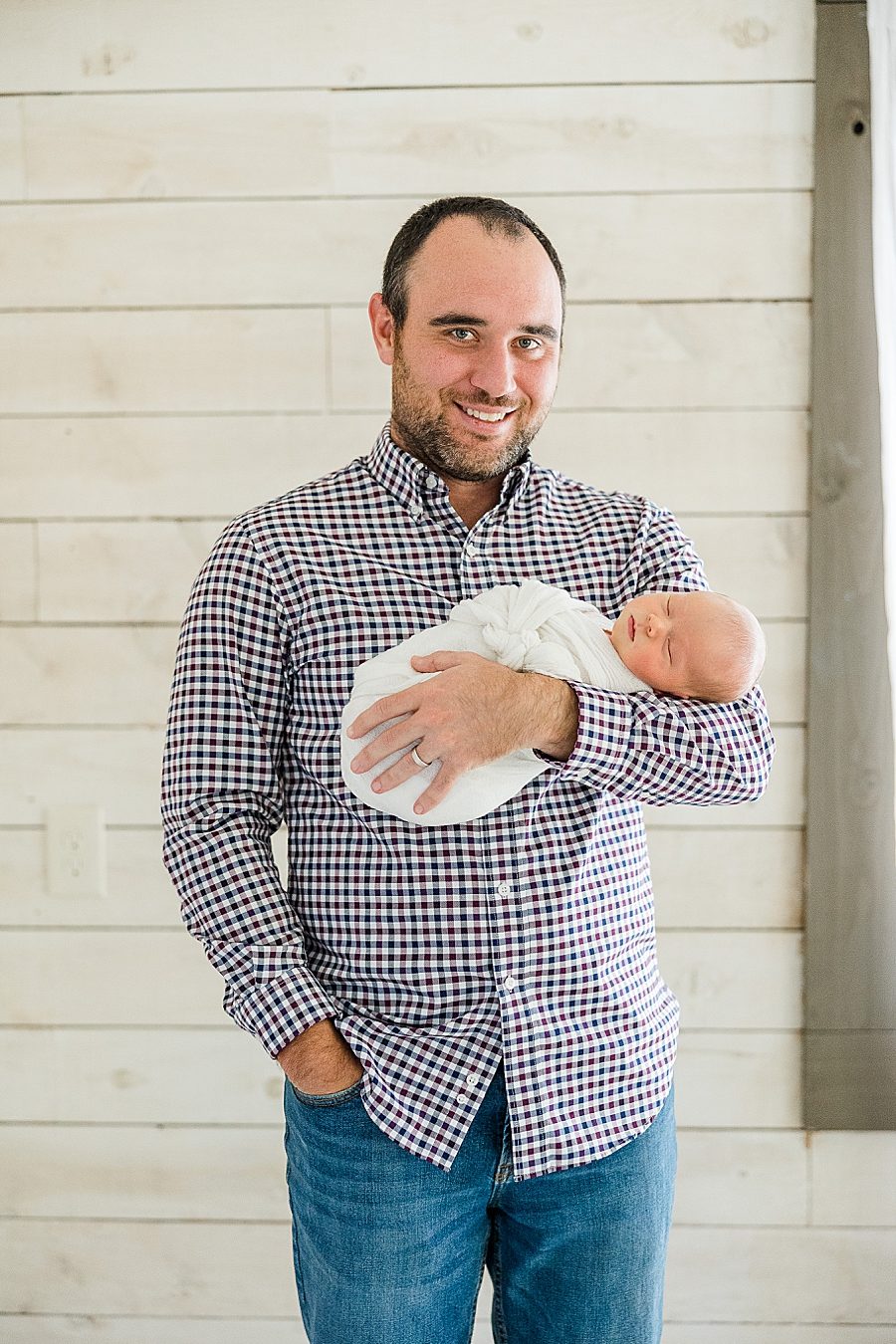 dad holding baby at this bright newborn session
