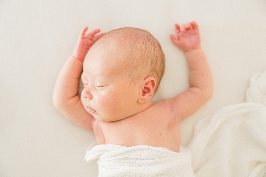 baby with arms over head