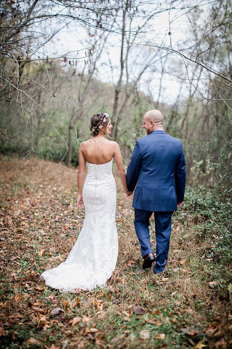 Bride and Groom walking away holding hands at this Alpine Village Wedding Chapel by Knoxville Wedding Photographer, Amanda May Photos.