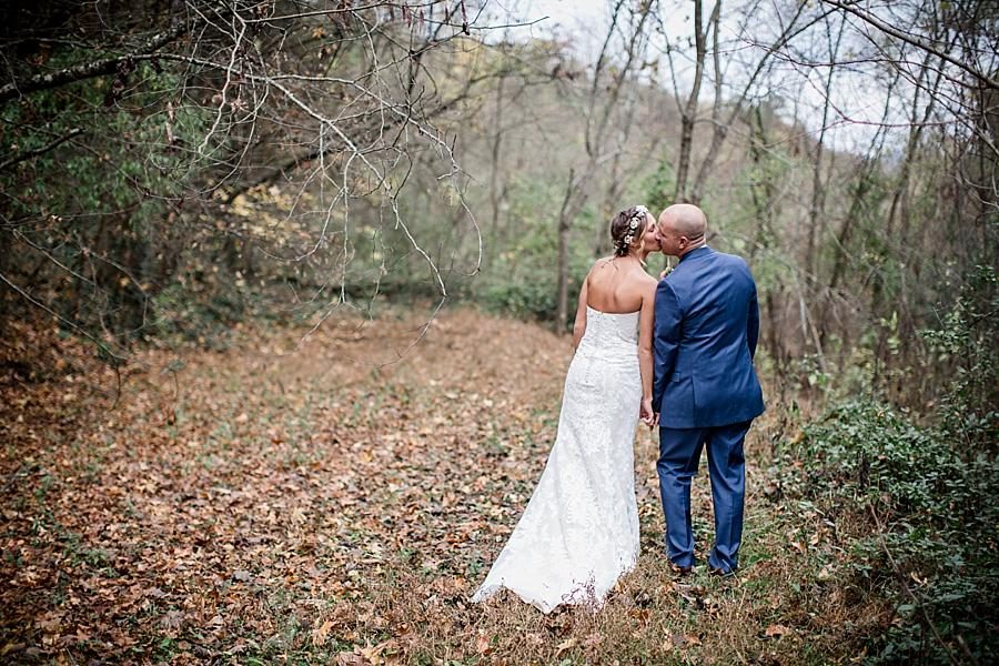 Bride and Groom kissing in the woods at this Alpine Village Wedding Chapel by Knoxville Wedding Photographer, Amanda May Photos.